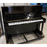 Yamaha (c1973) A Model U1 upright piano in a bright ebonised case.