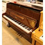 Weinbach (c1983) An upright piano in a bright sapele mahogany case.