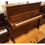 Welmar (c1982) An upright piano in a traditional satin walnut case.