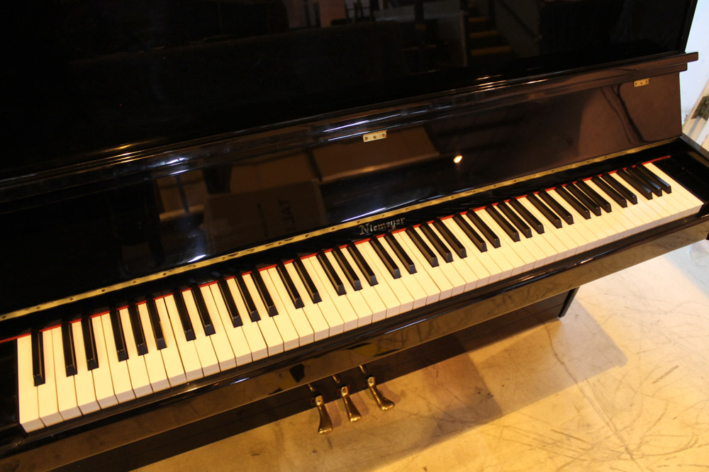 Niemeyer A recent upright piano in a modern style bright ebonised case; together with a stool. - Image 4 of 6