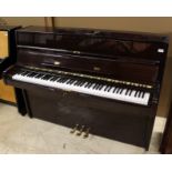 Elysian A recent upright piano in a modern style bright mahogany case;