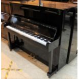 Kawai (c1962) An upright piano in a traditional style bright ebonised case