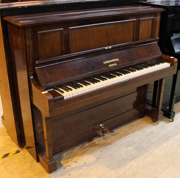 Bechstein (c1900) An upright piano in a rosewood case.