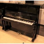 Yamaha (c1959) A Model U2A upright piano in a bright ebonised case.