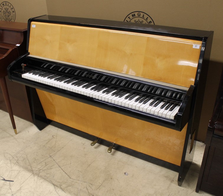 Schimmel (c1957) An upright piano in a modern style maple and ebonised trimmed case.