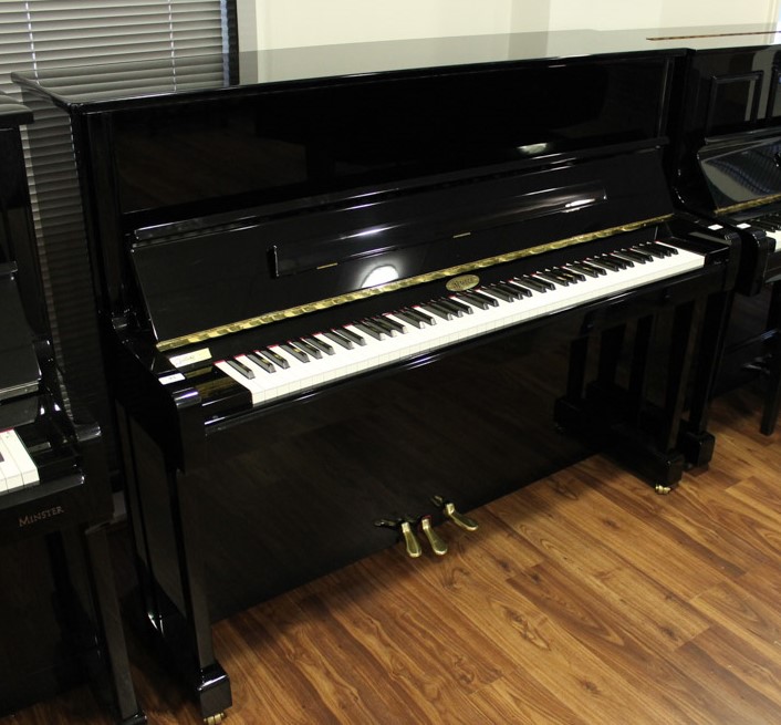Kemble (c2014) A Model K121CL upright piano in a bright ebonised case.