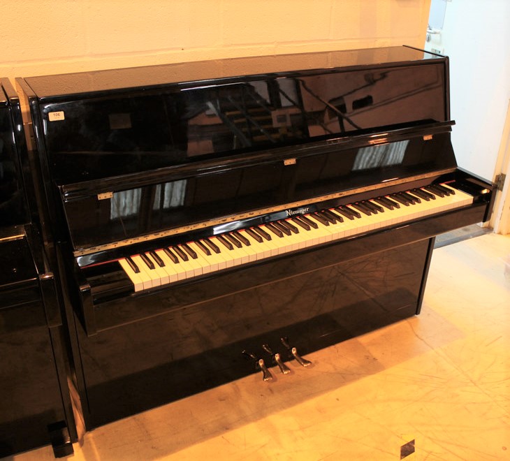 Niemeyer A recent upright piano in a modern style bright ebonised case; together with a stool.