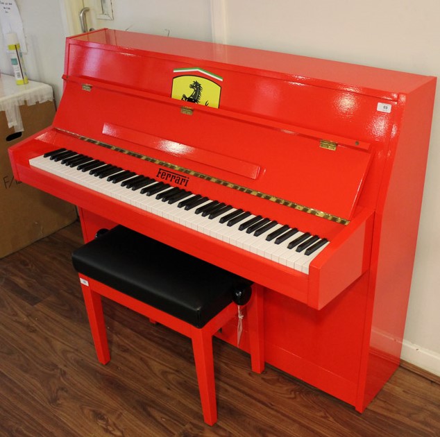 Upright Piano A recent upright piano in a modern style case decorated in the red Ferrari livery.