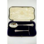 An Edwardian silver pusher and spoon, with flared reeded terminals, London 1909,