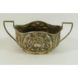 A late Victorian oval two-handled silver sugar bowl, with embossed decoration, Birmingham 1897,