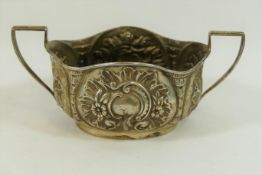 A late Victorian oval two-handled silver sugar bowl, with embossed decoration, Birmingham 1897,
