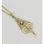 An Edwardian style yellow metal fresh water pearl and diamond openwork pendant, 5cm long,