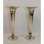 A pair of Edwardian silver trumpet shaped vases, Birmingham 1909, with wavy rims and loaded bases,