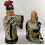 Two Japanese pottery glazed, polychrome enamel and gilt decorated figures of immortals,