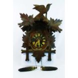 A 20th century Black Forest cuckoo clock, of typical bird and leaf form,
