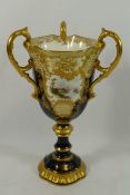 A Coalport three handled pedestal cup,