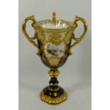 A Coalport three handled pedestal cup,