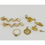 Four 9 carat gold items comprised of three charms and a small gem set ring, 7.