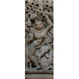 A large Indian deeply carved wooden panel of a Hindu deity, 91cm x 38cm, and a smaller erotic panel,
