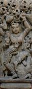 A large Indian deeply carved wooden panel of a Hindu deity, 91cm x 38cm, and a smaller erotic panel,