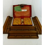A leather cased Mahjong set with plastic counters, original instructions,