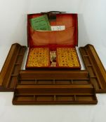 A leather cased Mahjong set with plastic counters, original instructions,