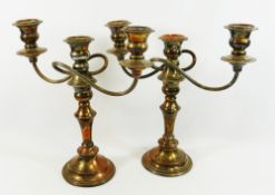 A pair of 'Falstaff' silver plate on copper twin branch three light candleabra, with beaded detail,