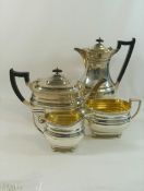 A George VI silver four piece tea set, Sheffield 1938, with gadrooned rim and raised on ball feet,