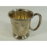 A small christening cup, with C scroll handle raised on circular foot, Birmingham 1954,