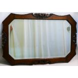 An early 20th century oak framed wall mirror with octagonal bevel glass plate,