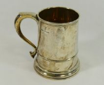A George VI silver tankard, with straight sides, scroll handle and stepped foot,