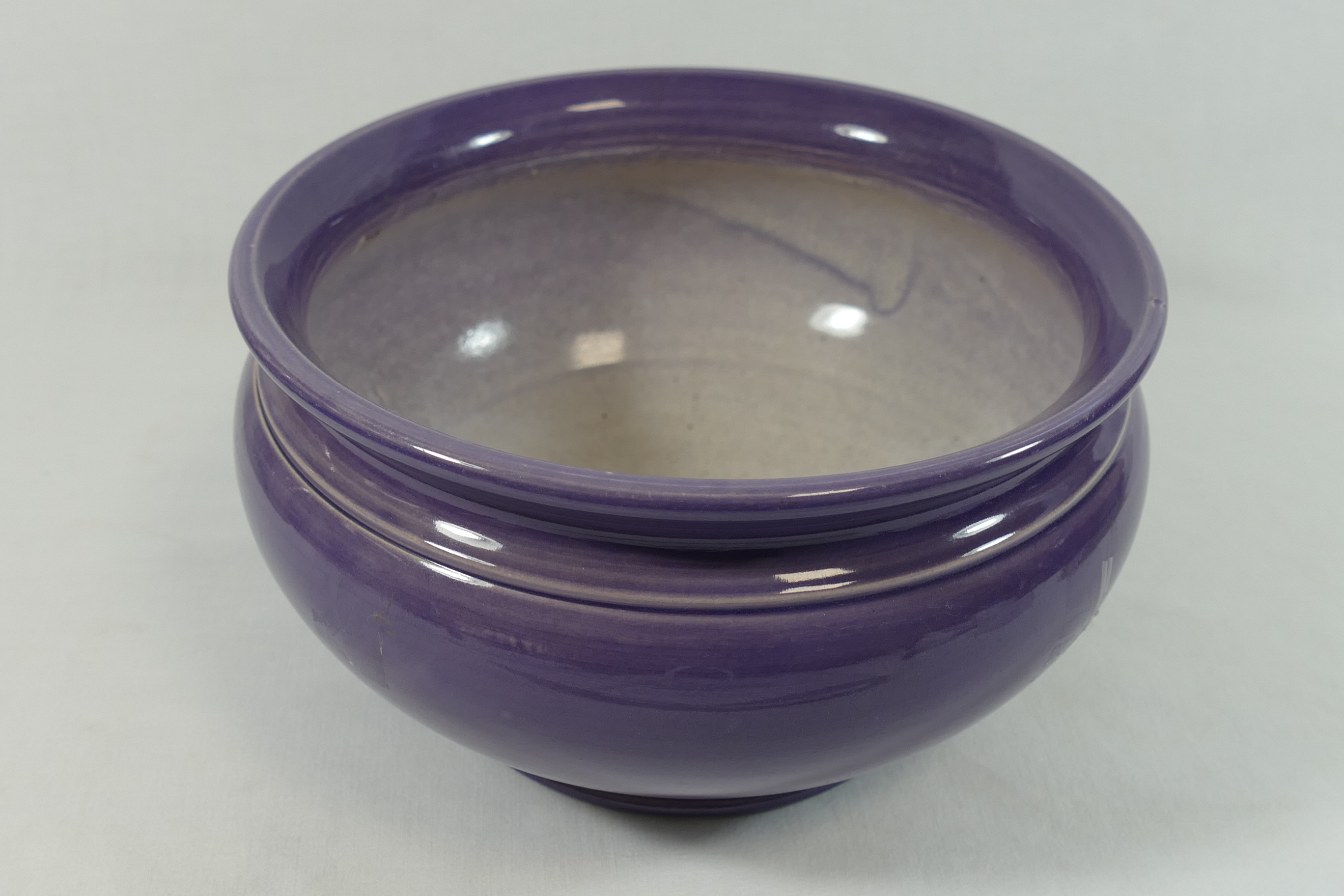 A Bretby pottery bowl, with purple glaze,