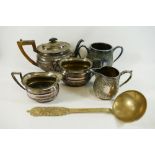 A large brass ladle with hammered design, 33cm long, a silver plated three piece teaset,