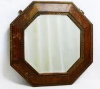 A small early 20th century octagonal oak framed wall mirror with bevelled glass plate, 44.