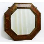 A small early 20th century octagonal oak framed wall mirror with bevelled glass plate, 44.