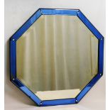 An octagonal glass mirror in the Venetian style, with blue glass surround,