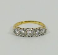 A yellow metal diamond five stone carved half hoop ring,