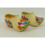 A pair of Clarice Cliff crocus pattern clogs, with painted Bizarre pattern marks,