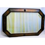 An early 20th century oak framed wall mirror with octagonal bevel glass plate,