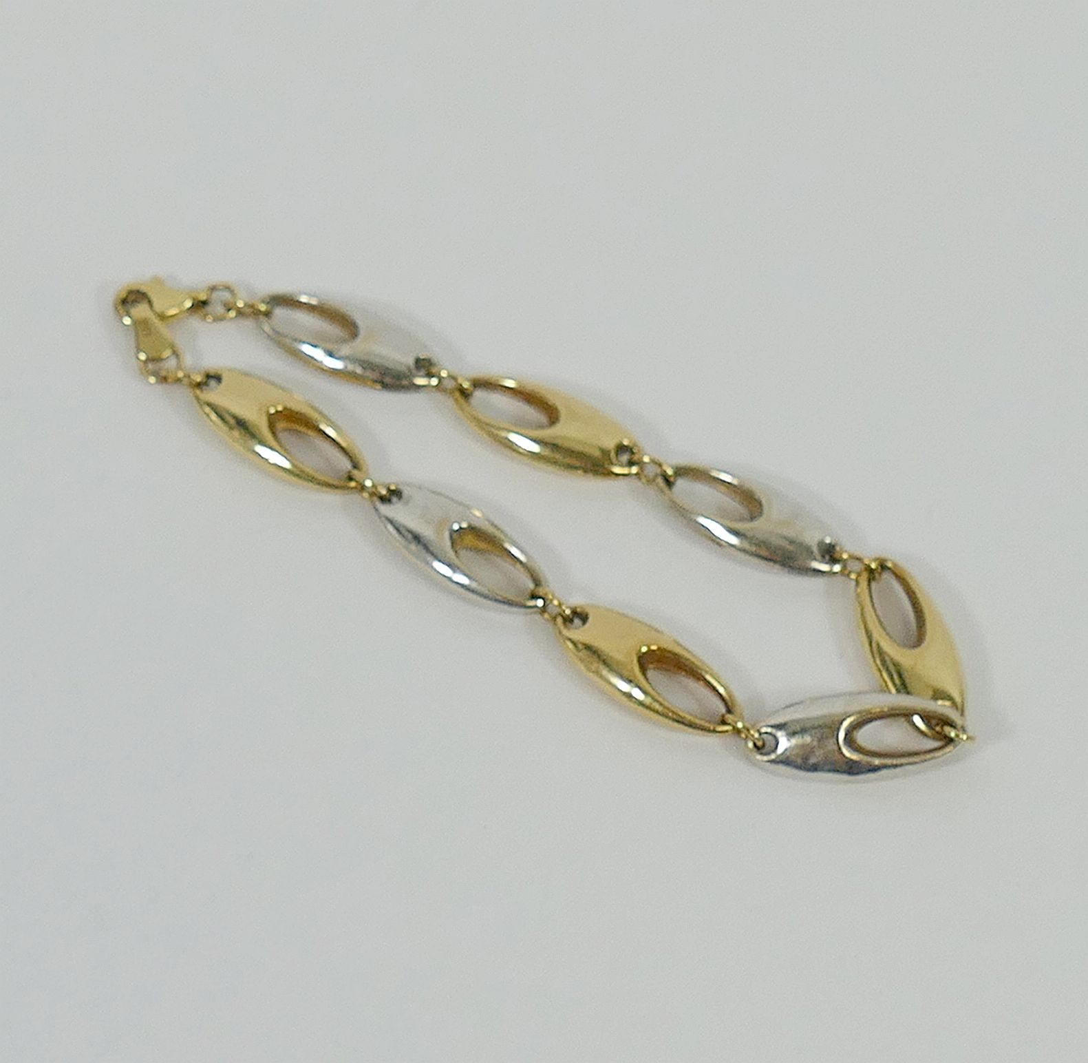 A 9 carat gold, bi-colour bracelet, with hollow links,
