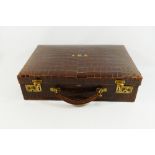 A crocodile leather documents case with brass fittings, retailed by John Pound and Co.