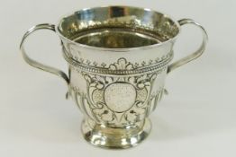 A George I silver porringer, with reeded scroll handles and half reeded and fluted body,