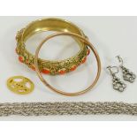 A coral and gilt bangle and a gold and silver bangle,