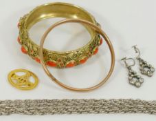 A coral and gilt bangle and a gold and silver bangle,