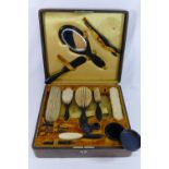 A Victorian ebony travelling dressing set, comprised of six brushes, a hand mirror,