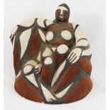 Signe Kolding (20th/21st century Danish)+ Stoneware sculpture of a seated woman, decorated in red,
