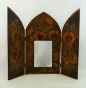 A wooden penwork triptych picture frame, decorated with poppies within hand punched surround,