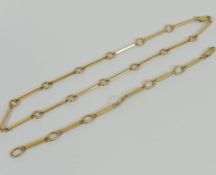 A yellow metal necklace and bracelet, with circular and bar links, the clasps stamped '375',