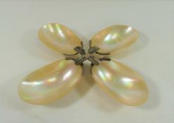 A set of four mother of pearl dishes with silver coloured metal mounts, approximately 10.