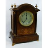 An early 20th century dome topped rosewood cased inlaid mantle clock,